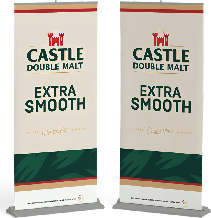 Two standing banners display the "Castle Double Malt Extra Smooth" branding with a red castle logo and green text on a cream background.